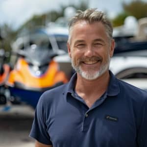 A man smiling in front of a new boat