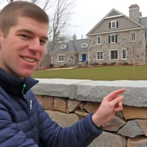 A man pointing to his recent purchased home.